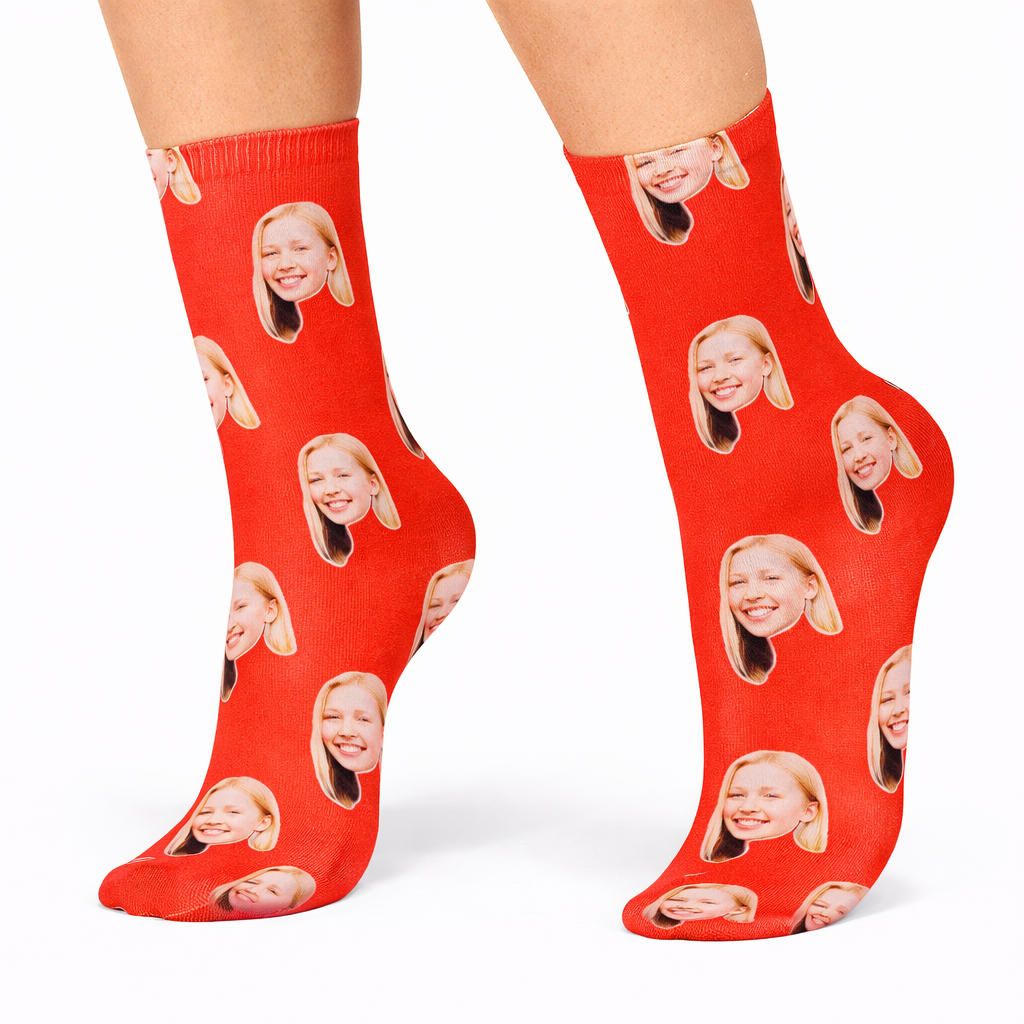 Red socks with a pattern of a smiling face on a white background
