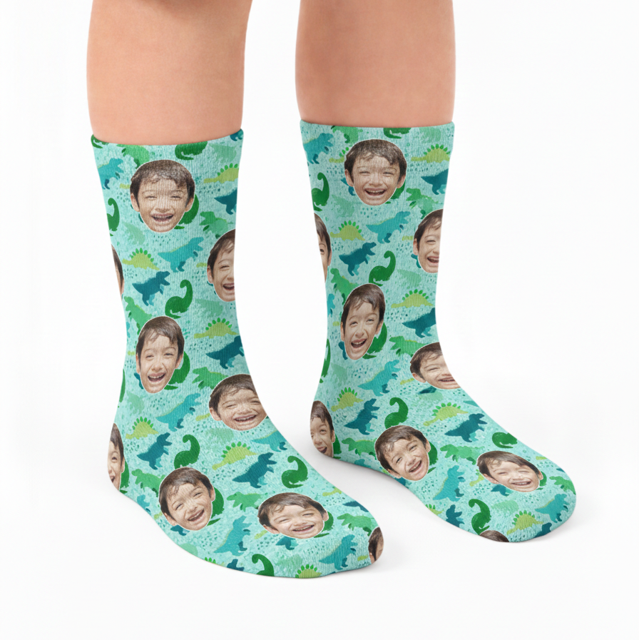 Socks with a pattern of faces and dinosaurs on a blue background