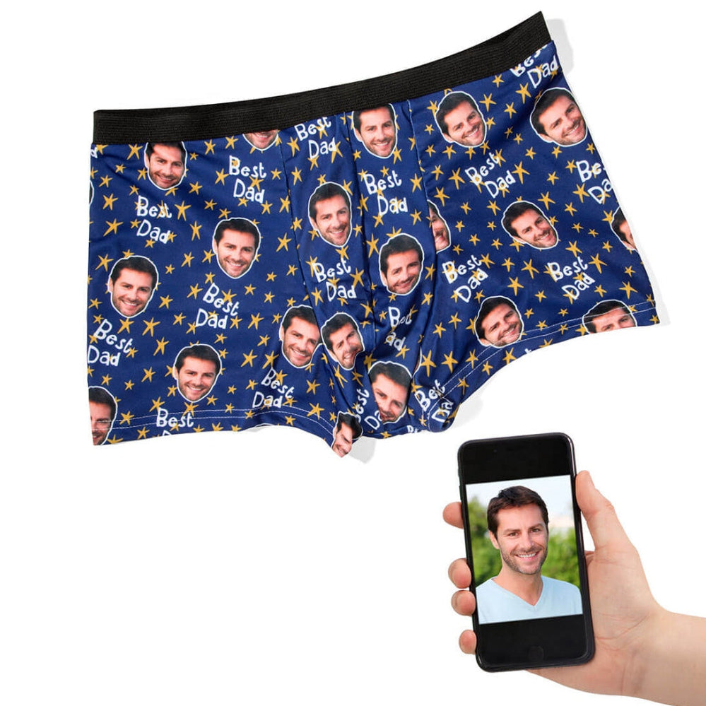 Personalized underwear with 'Best Dad' print, held by a hand with a phone showing a photo.
