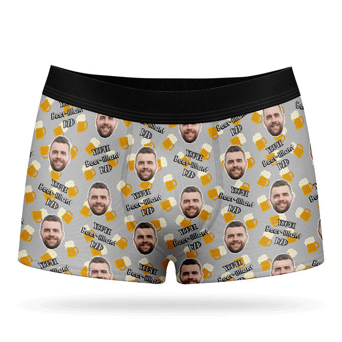 A pair of red custom boxers with a pattern of a man's face and beer bottles.