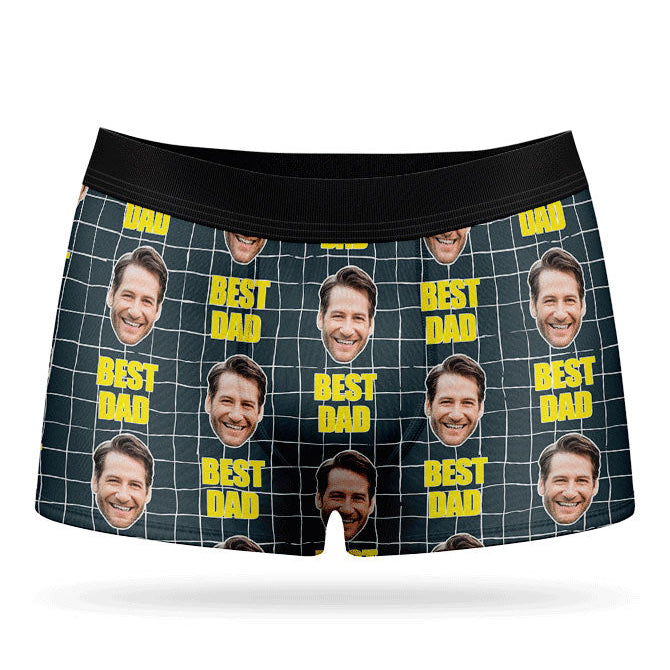 A pair of custom boxer briefs with multiple photos of a person in a grid pattern against a yellow background, with the text 'BEST DAD' repeated across the waistband.