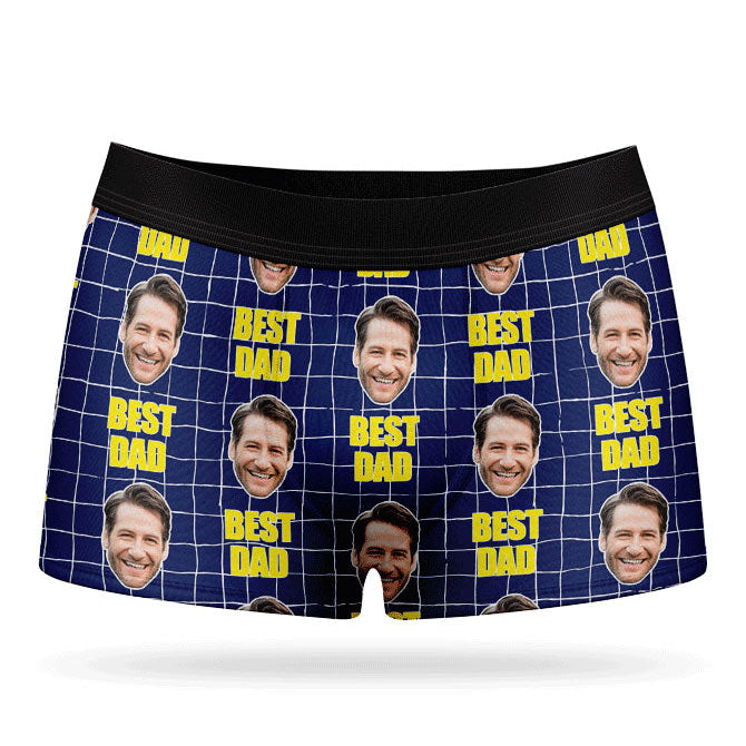 A pair of custom boxer briefs with multiple photos of a person in a grid pattern against a yellow background, with the text 'BEST DAD' repeated across the waistband.