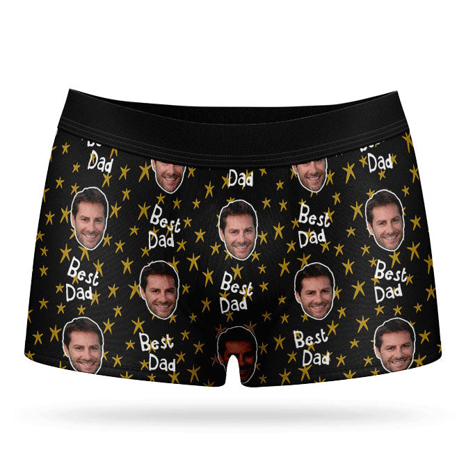 A pair of custom boxers with a pattern of a man's face and the text 'Best Dad', predominantly in a blue color.