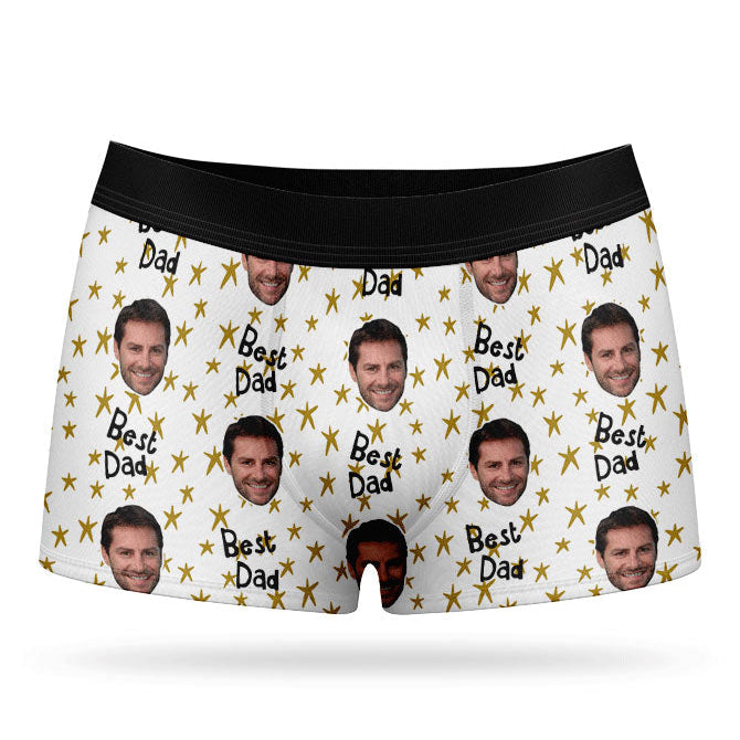 A pair of custom boxers with a pattern of a man's face and the text 'Best Dad', predominantly in a blue color.
