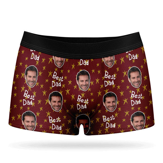A pair of custom boxers with a pattern of a man's face and the text 'Best Dad', predominantly in a blue color.