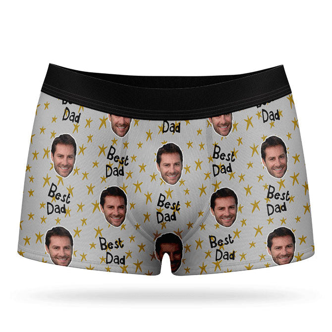 A pair of custom boxers with a pattern of a man's face and the text 'Best Dad', predominantly in a blue color.