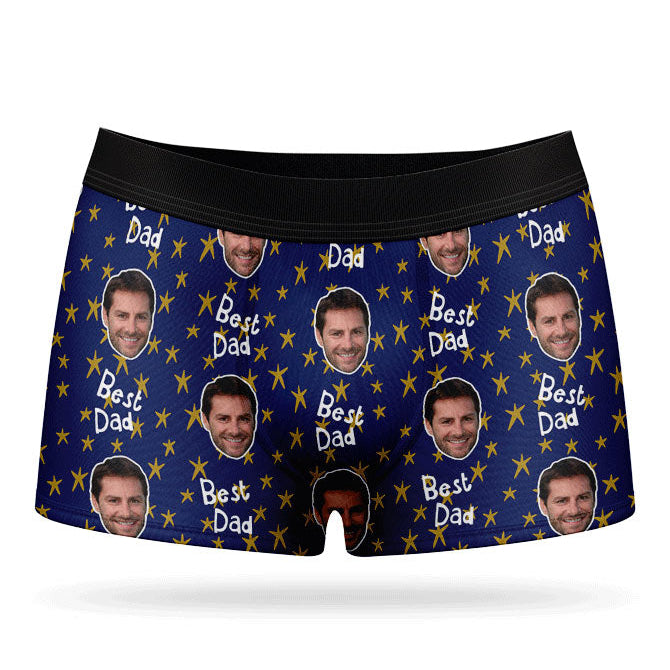 A pair of custom boxers with a pattern of a man's face and the text 'Best Dad', predominantly in a blue color.