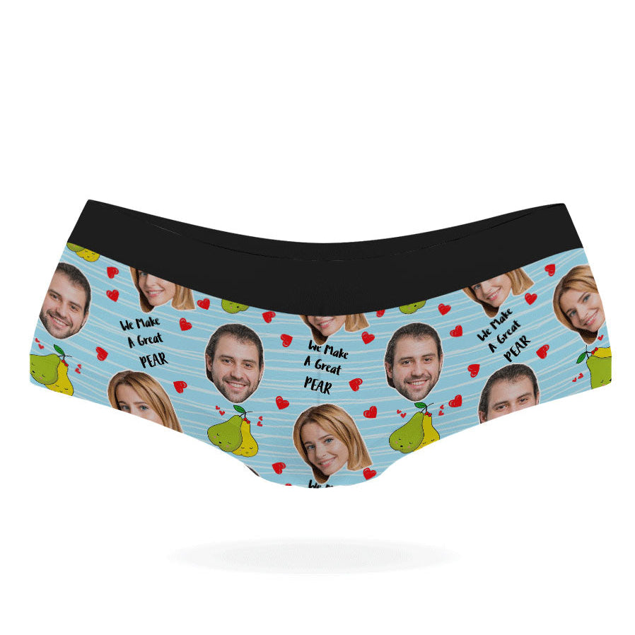 A pair of pink personalized panties with multiple faces printed on them, featuring a black elastic waistband.