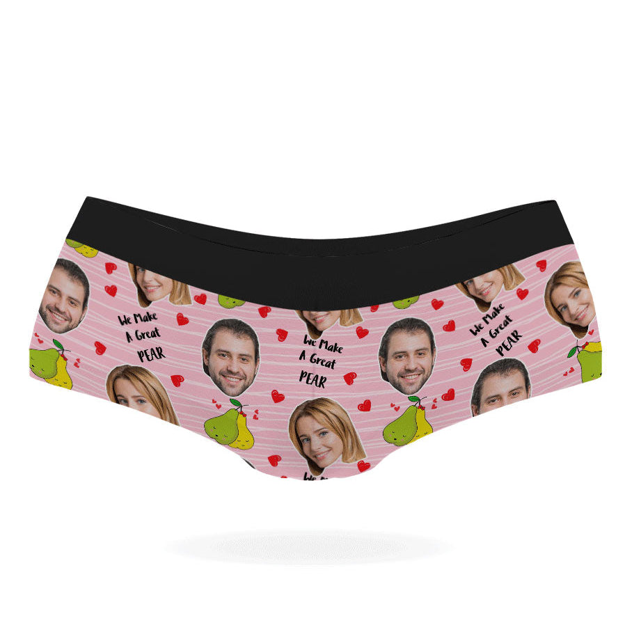 A pair of pink personalized panties with multiple faces printed on them, featuring a black elastic waistband.
