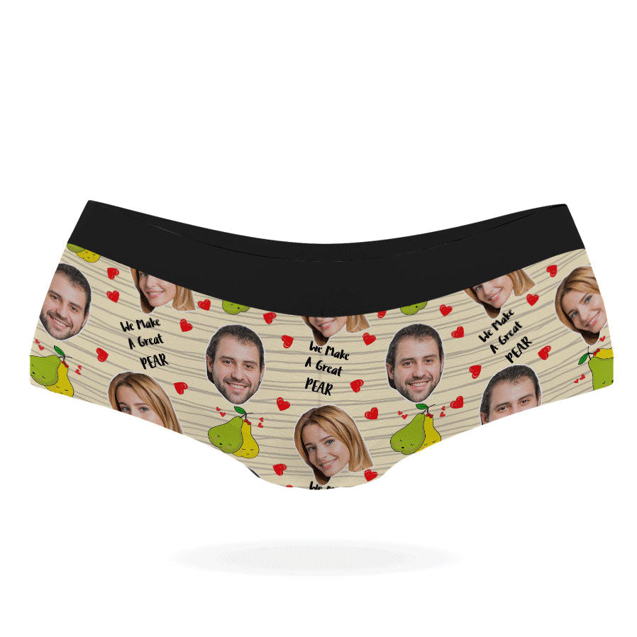 A pair of pink personalized panties with multiple faces printed on them, featuring a black elastic waistband.