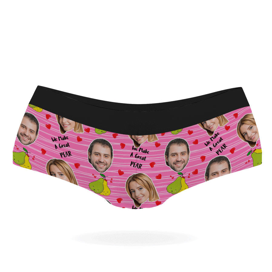 A pair of pink personalized panties with multiple faces printed on them, featuring a black elastic waistband.