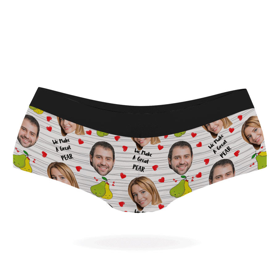 A pair of pink personalized panties with multiple faces printed on them, featuring a black elastic waistband.