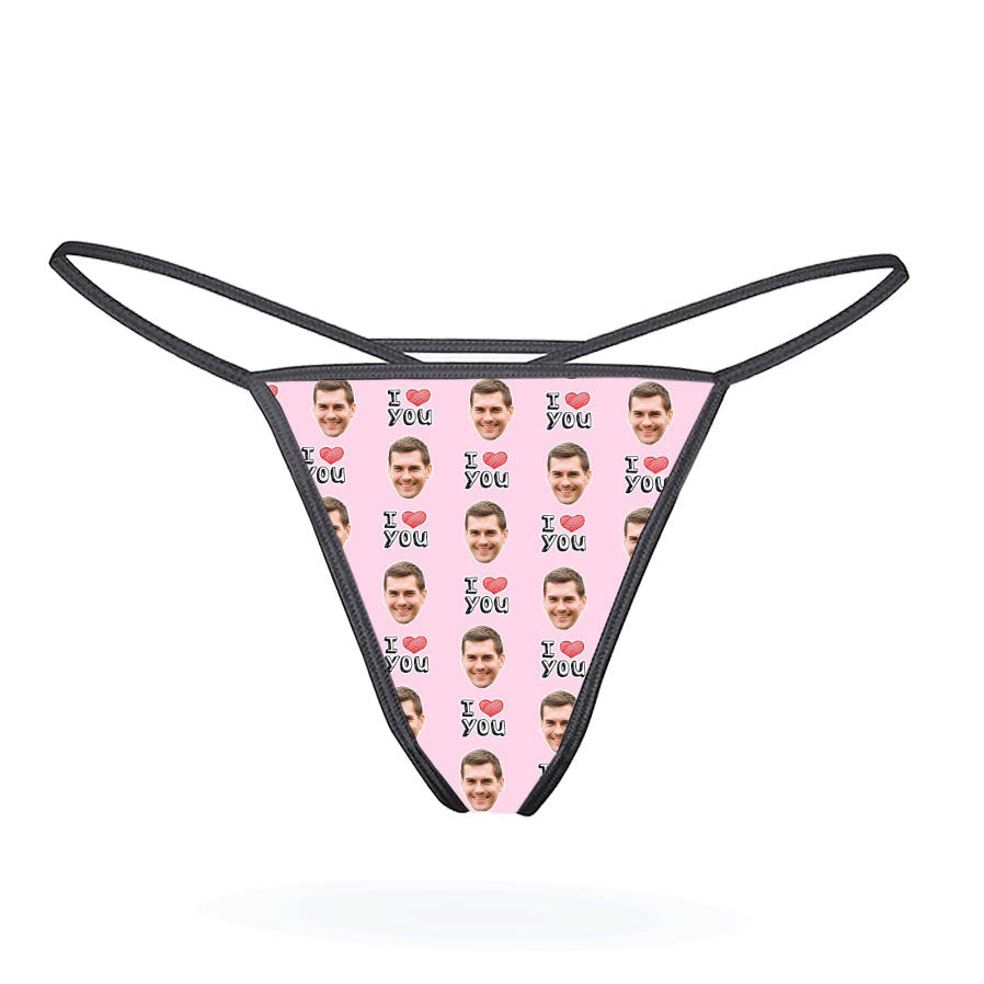 A custom thong with a repeated pattern of a face and the text 'I HEART YOU' in a red and blue color scheme on a black background.