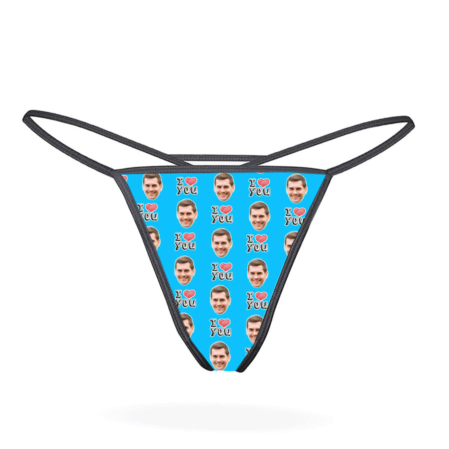 A custom thong with a repeated pattern of a face and the text 'I HEART YOU' in a red and blue color scheme on a black background.