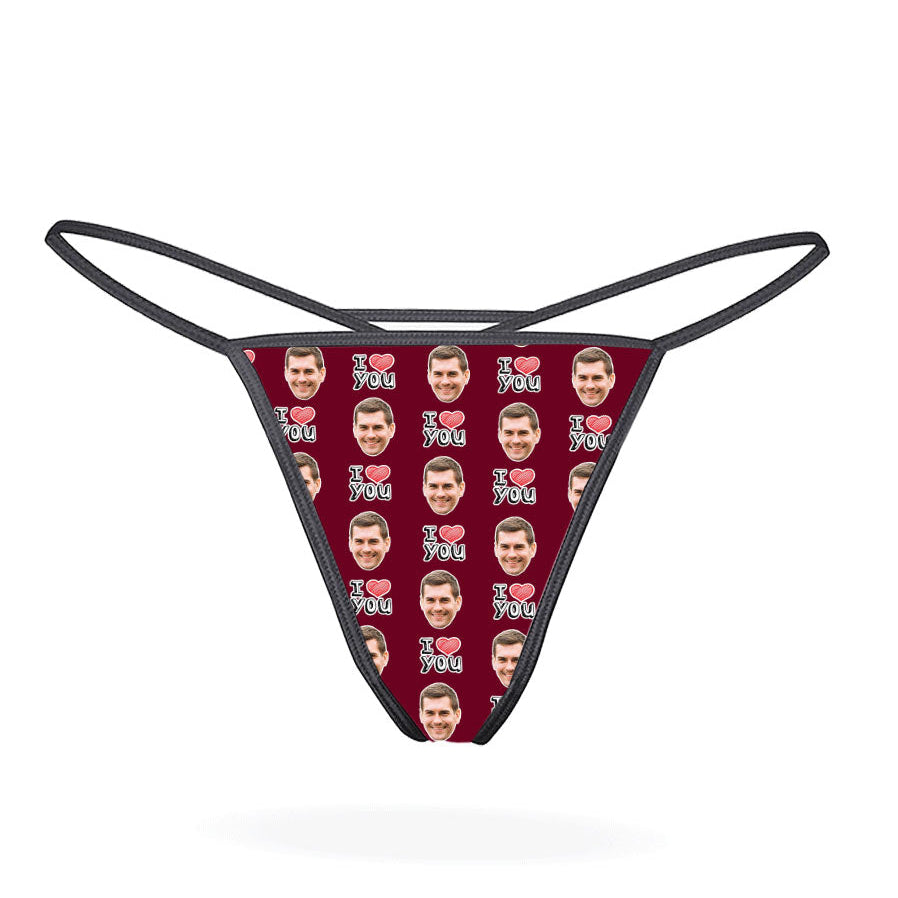 A custom thong with a repeated pattern of a face and the text 'I HEART YOU' in a red and blue color scheme on a black background.