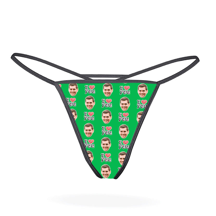 A custom thong with a repeated pattern of a face and the text 'I HEART YOU' in a red and blue color scheme on a black background.