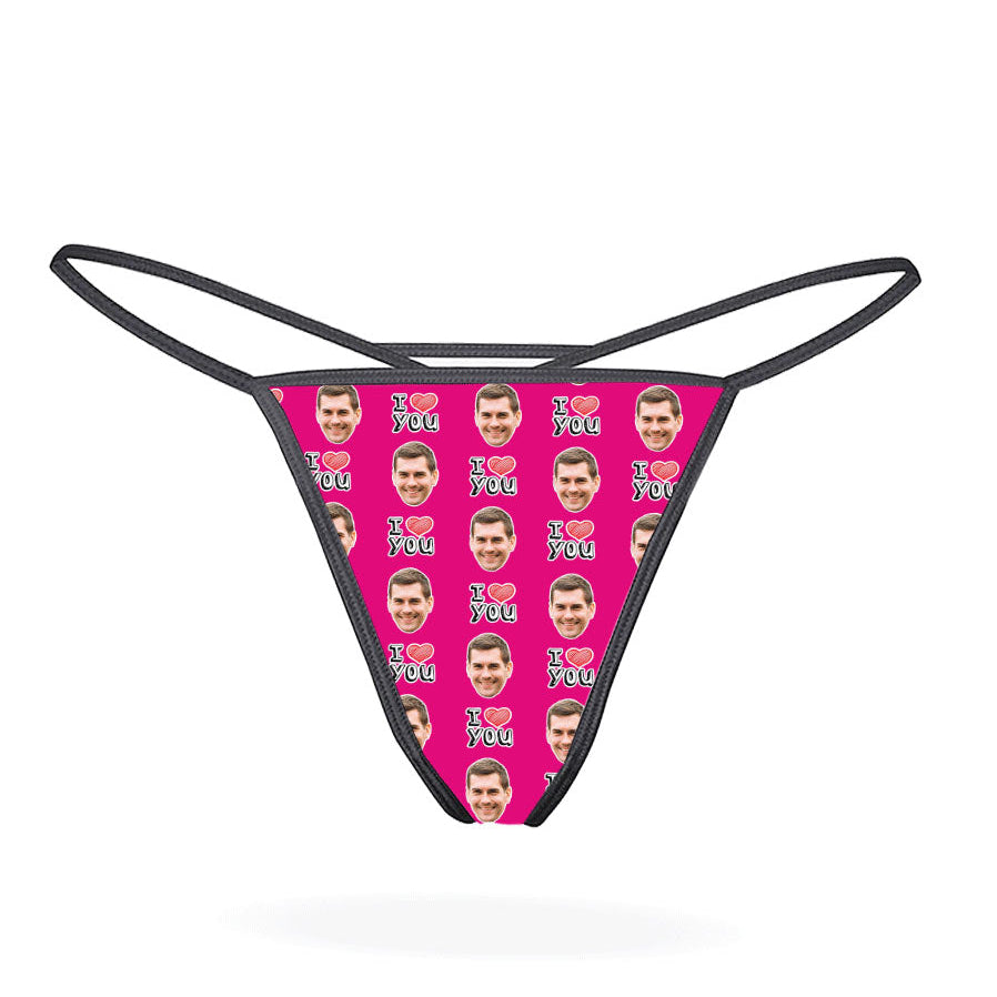 A custom thong with a repeated pattern of a face and the text 'I HEART YOU' in a red and blue color scheme on a black background.