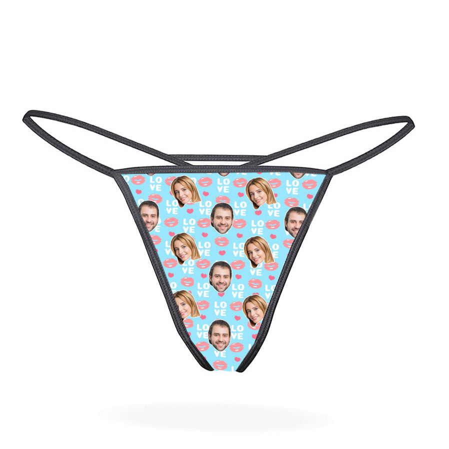 This image displays the "Love Lips Custom Thong," a playful and customizable piece of lingerie. The thong features a vibrant purple design covered with a repeated pattern of the phrase "I love you" in a stylized font, accompanied by lips and hearts motifs.