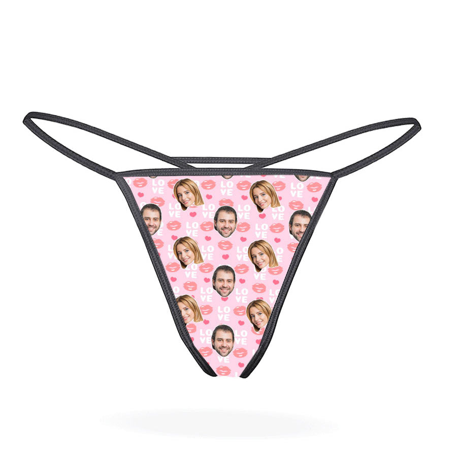This image displays the "Love Lips Custom Thong," a playful and customizable piece of lingerie. The thong features a vibrant purple design covered with a repeated pattern of the phrase "I love you" in a stylized font, accompanied by lips and hearts motifs.
