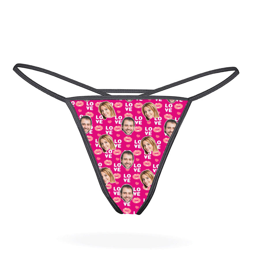 This image displays the "Love Lips Custom Thong," a playful and customizable piece of lingerie. The thong features a vibrant purple design covered with a repeated pattern of the phrase "I love you" in a stylized font, accompanied by lips and hearts motifs.