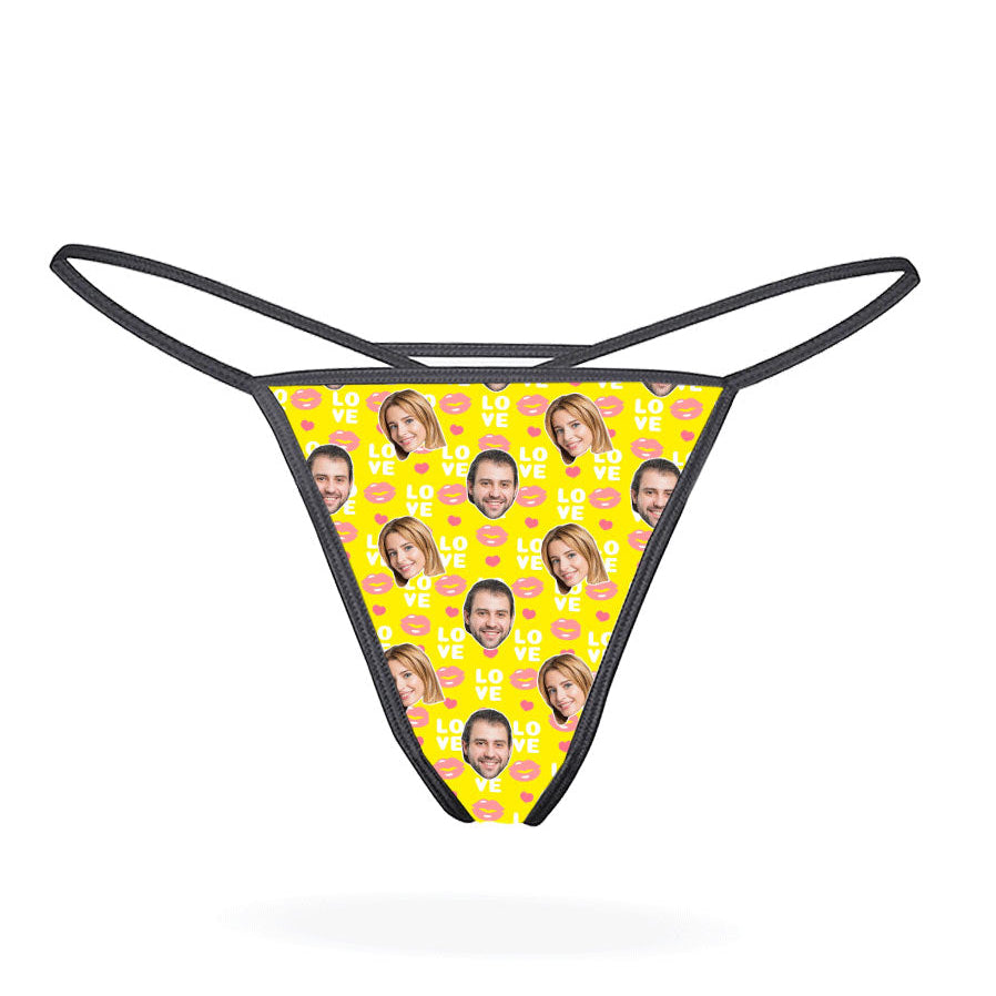 This image displays the "Love Lips Custom Thong," a playful and customizable piece of lingerie. The thong features a vibrant purple design covered with a repeated pattern of the phrase "I love you" in a stylized font, accompanied by lips and hearts motifs.