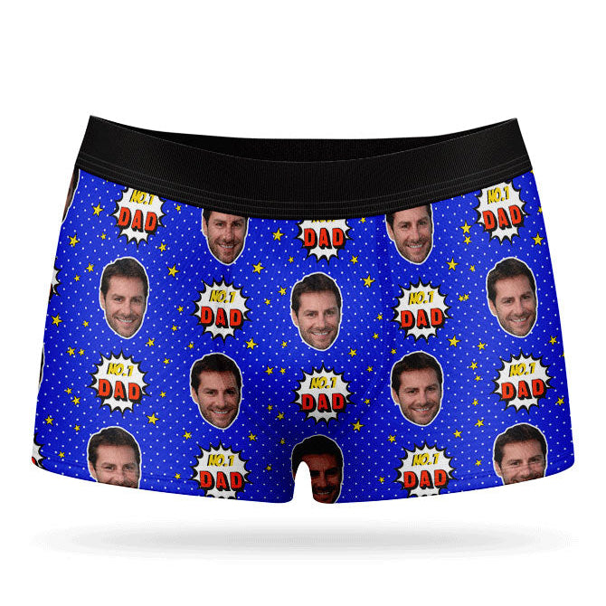 A pair of purple custom boxer briefs with a repeated pattern of a man's face and the text 'NUMBER 1 DAD'.