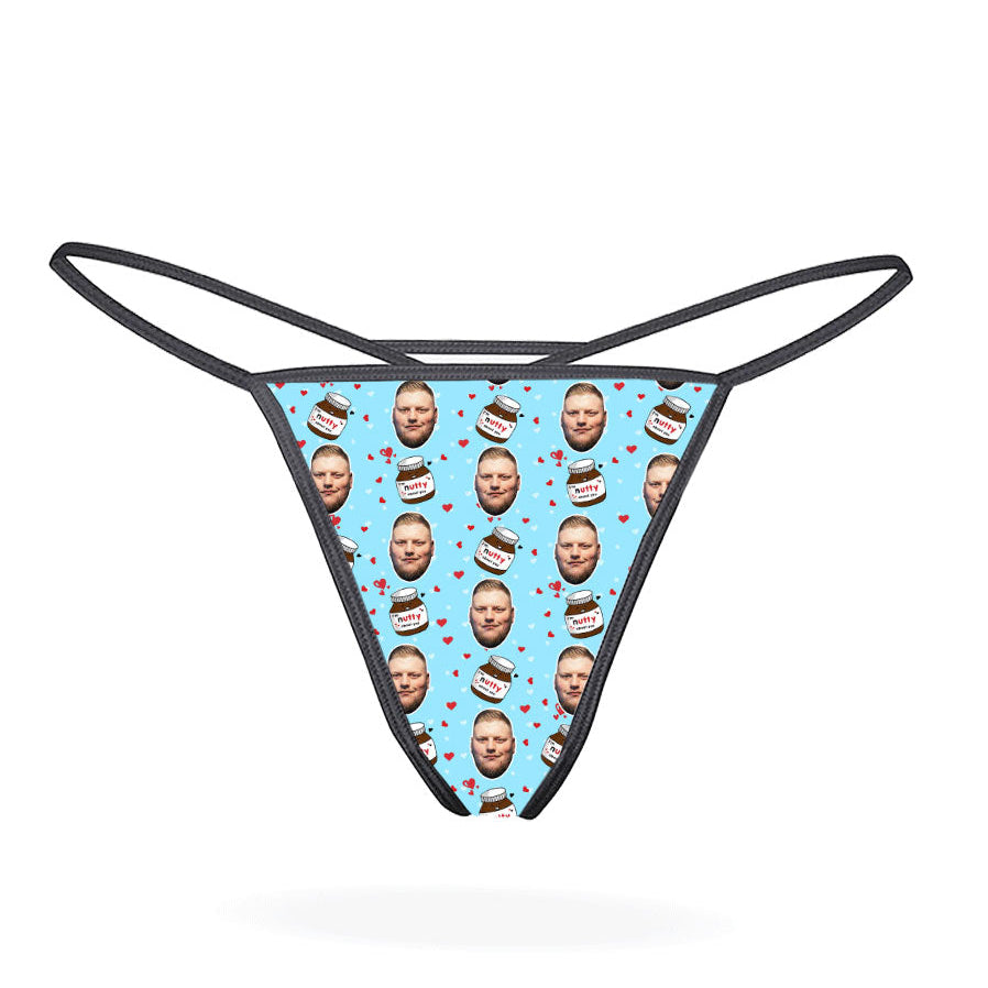 This image displays the "Nutty About You Custom Thong," a personalized piece of lingerie designed for customization. The thong features a vibrant, blue-colored design with multiple images of a man's face repeated in a pattern across the fabric.