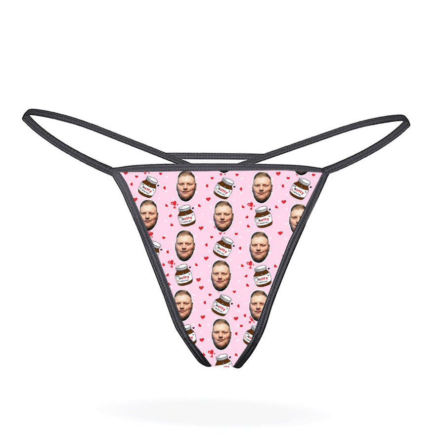 This image displays the "Nutty About You Custom Thong," a personalized piece of lingerie designed for customization. The thong features a vibrant, blue-colored design with multiple images of a man's face repeated in a pattern across the fabric.