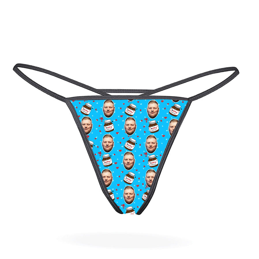 This image displays the "Nutty About You Custom Thong," a personalized piece of lingerie designed for customization. The thong features a vibrant, blue-colored design with multiple images of a man's face repeated in a pattern across the fabric.
