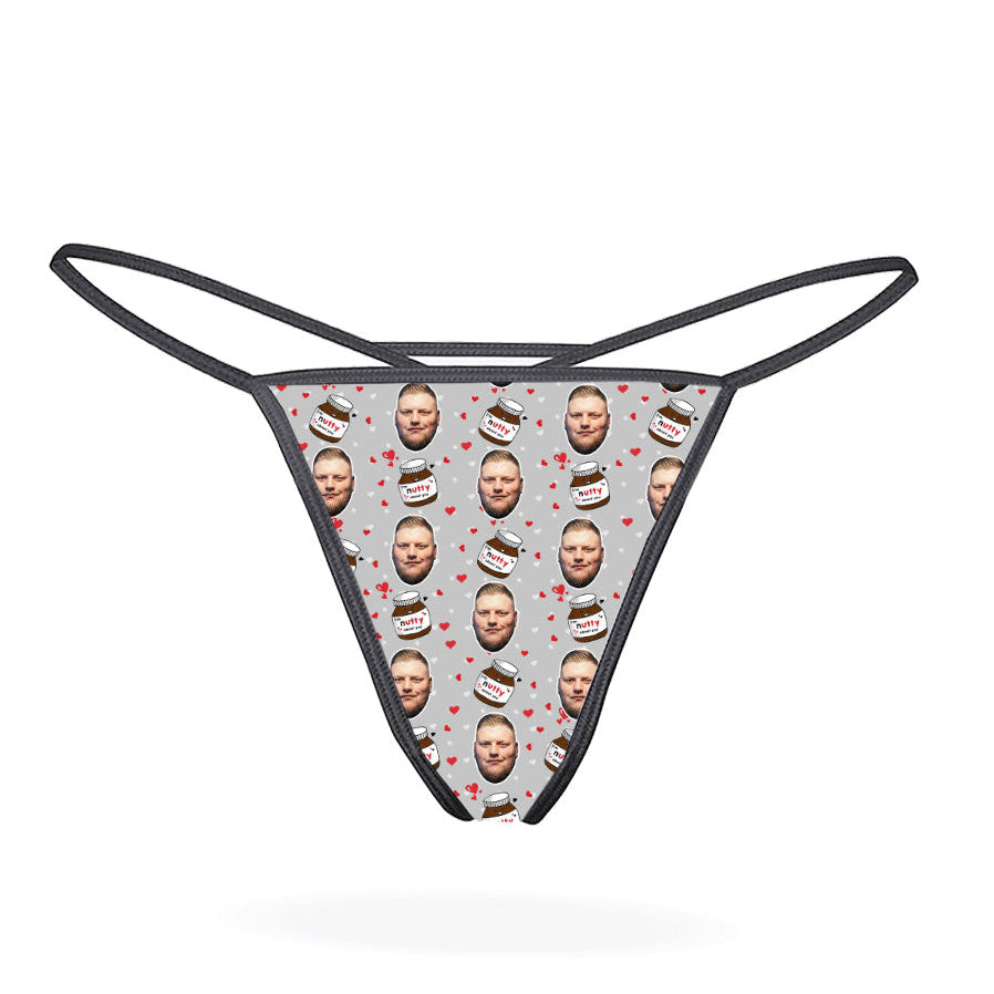 This image displays the "Nutty About You Custom Thong," a personalized piece of lingerie designed for customization. The thong features a vibrant, blue-colored design with multiple images of a man's face repeated in a pattern across the fabric.