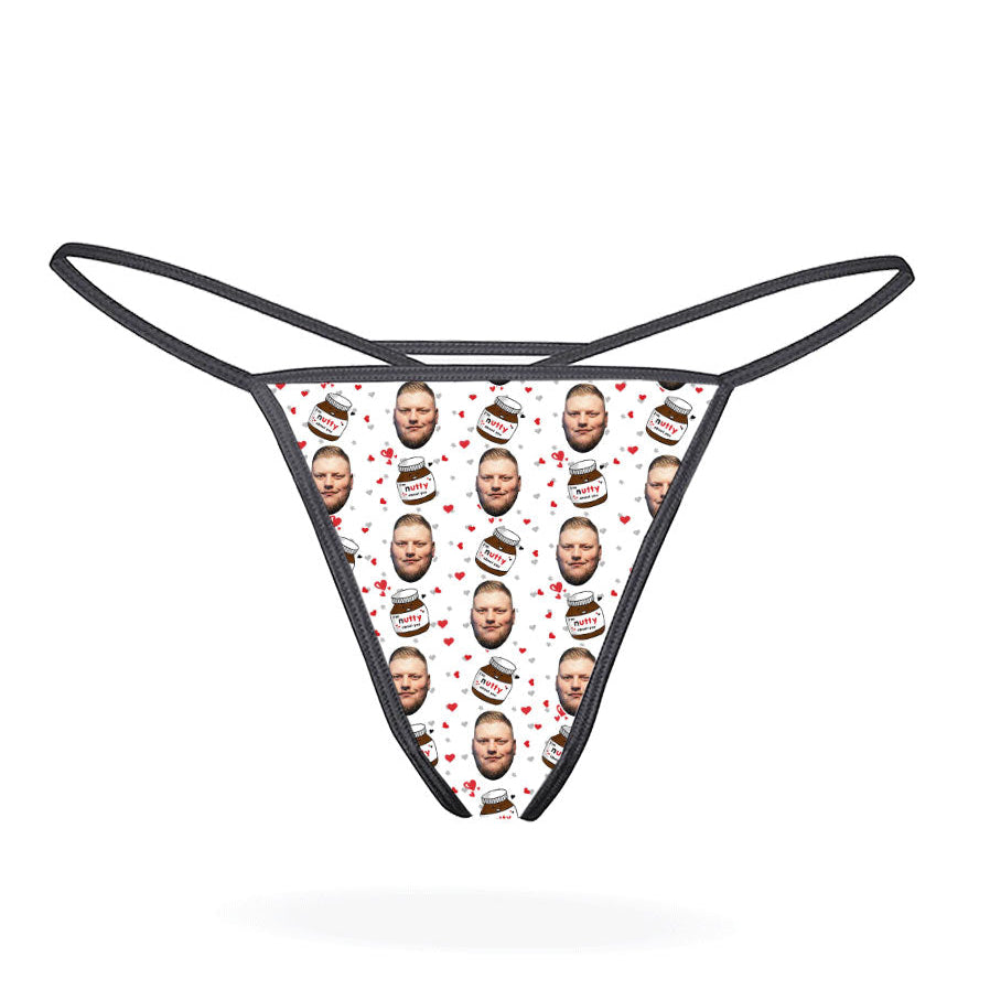 This image displays the "Nutty About You Custom Thong," a personalized piece of lingerie designed for customization. The thong features a vibrant, blue-colored design with multiple images of a man's face repeated in a pattern across the fabric.