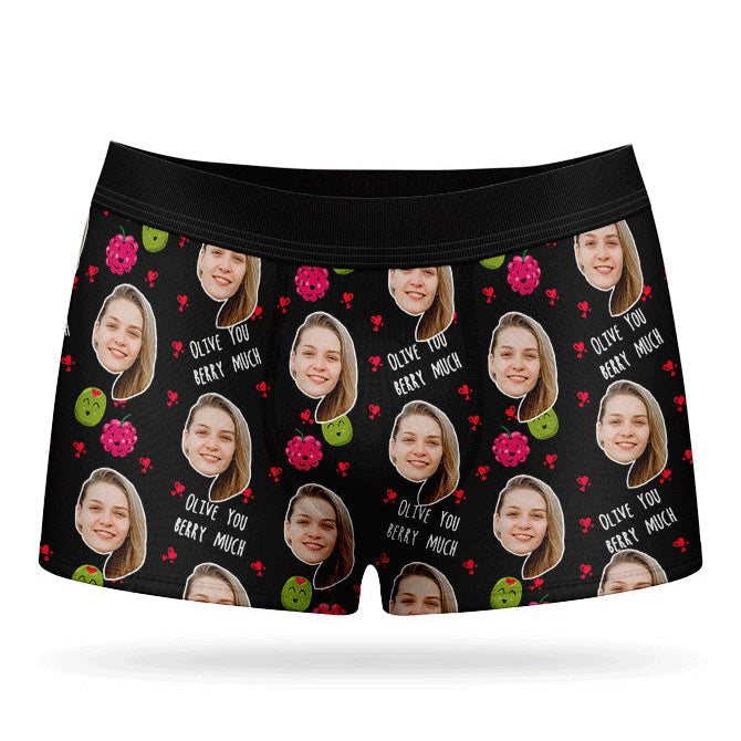 A pair of pink boxer shorts with a custom print of a couple's photos and the phrase 'Olive You Berry Much'.