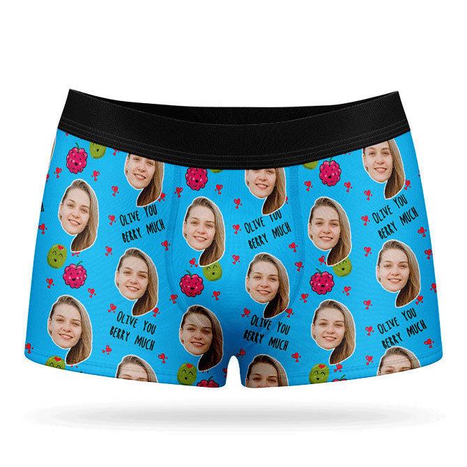 A pair of pink boxer shorts with a custom print of a couple's photos and the phrase 'Olive You Berry Much'.