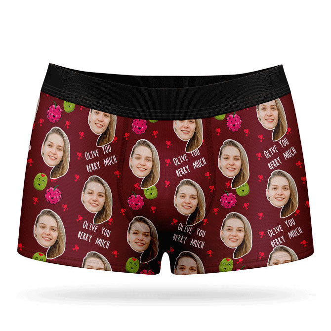 A pair of pink boxer shorts with a custom print of a couple's photos and the phrase 'Olive You Berry Much'.