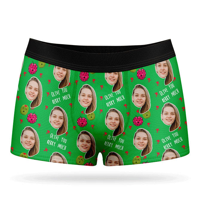 A pair of pink boxer shorts with a custom print of a couple's photos and the phrase 'Olive You Berry Much'.
