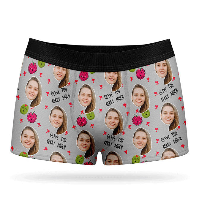 A pair of pink boxer shorts with a custom print of a couple's photos and the phrase 'Olive You Berry Much'.