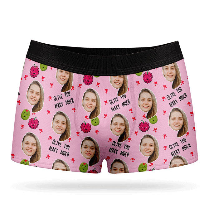 A pair of pink boxer shorts with a custom print of a couple's photos and the phrase 'Olive You Berry Much'.