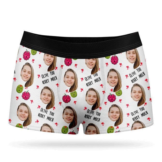 A pair of pink boxer shorts with a custom print of a couple's photos and the phrase 'Olive You Berry Much'.