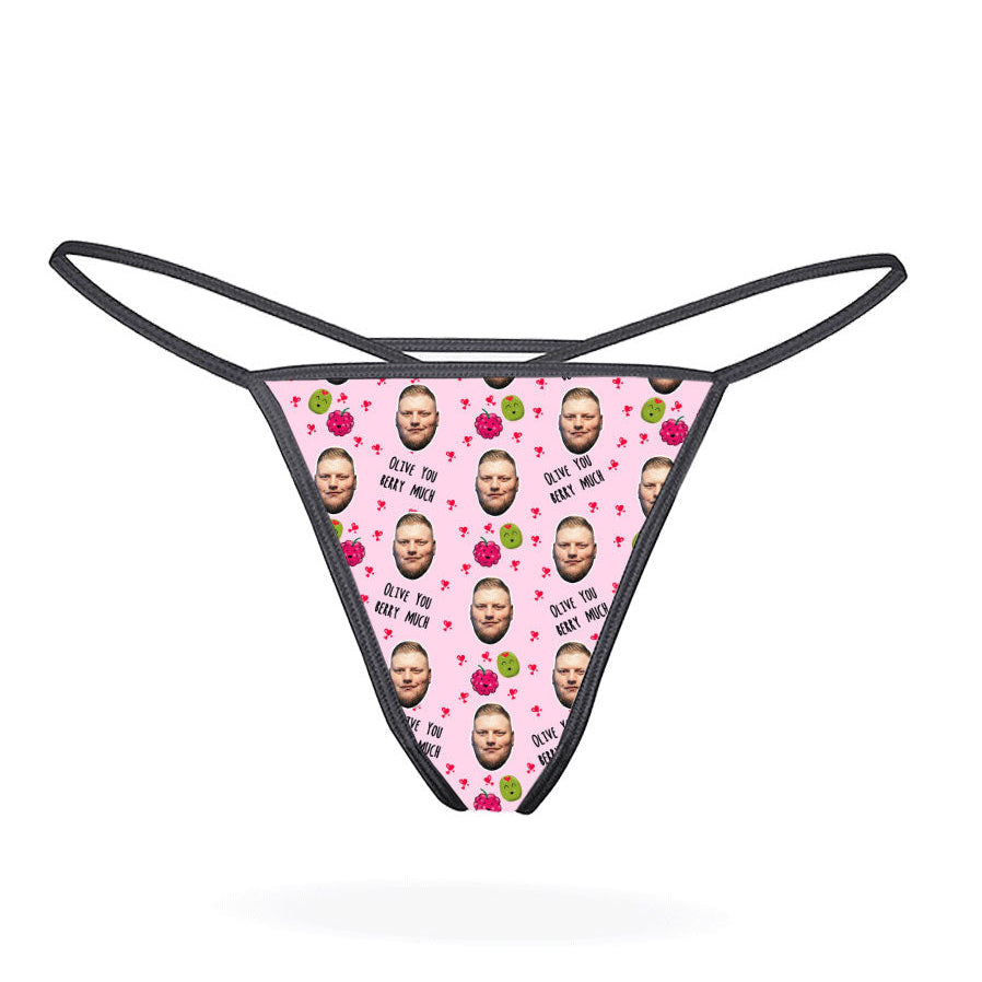 A pink thong with a pattern of cartoon characters displayed on the front.