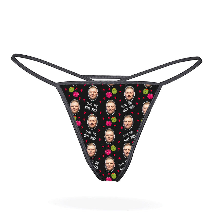 A pink thong with a pattern of cartoon characters displayed on the front.
