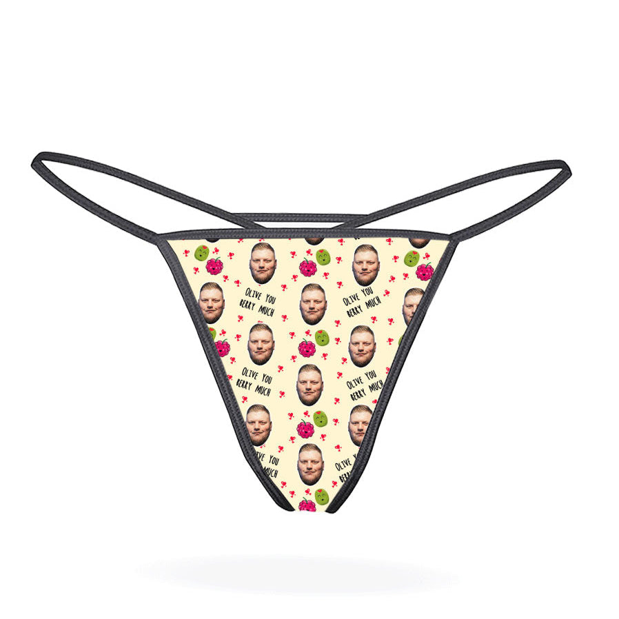 A pink thong with a pattern of cartoon characters displayed on the front.
