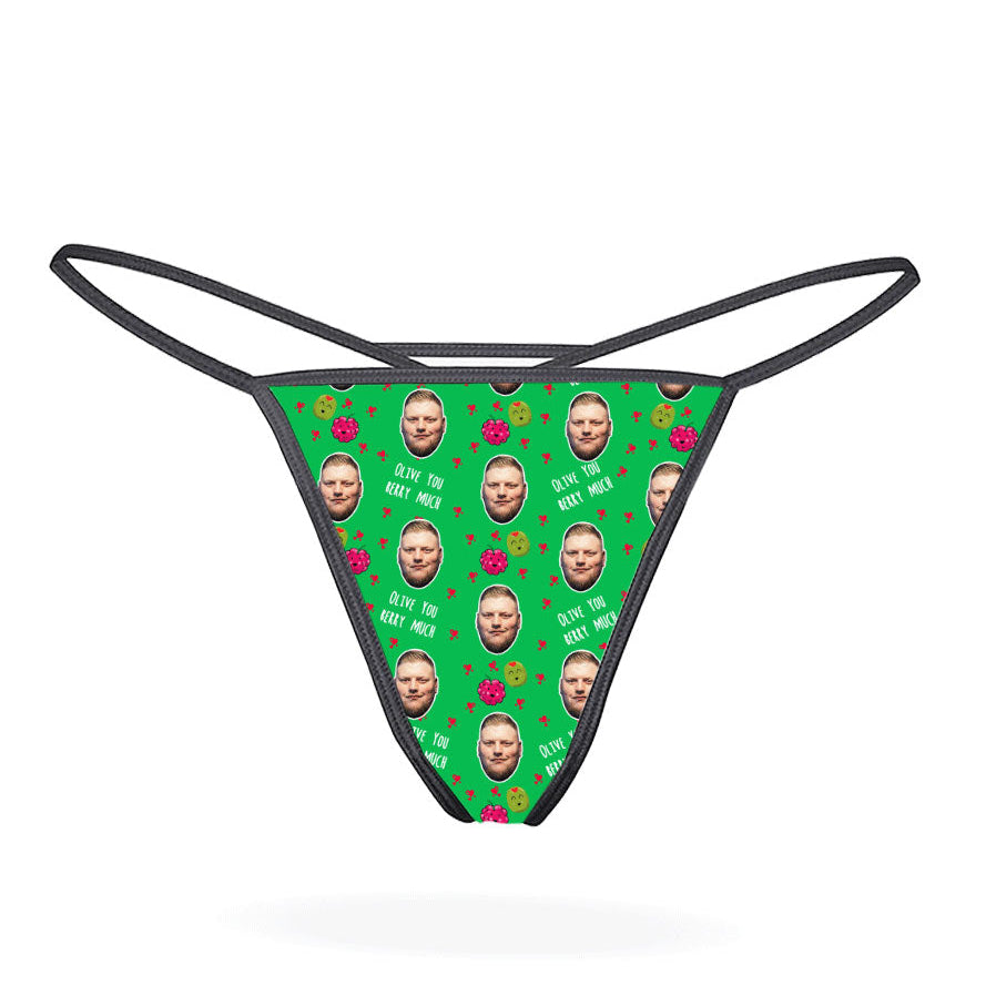 A pink thong with a pattern of cartoon characters displayed on the front.