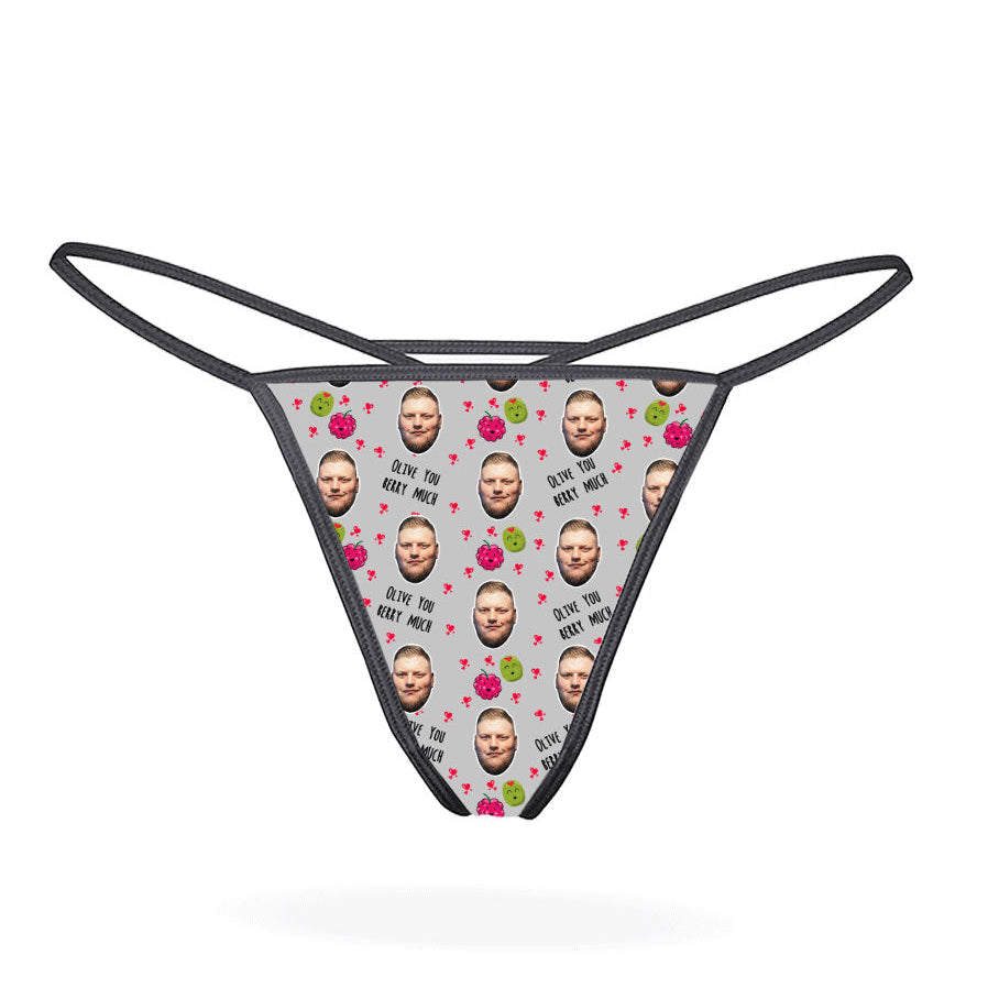 A pink thong with a pattern of cartoon characters displayed on the front.