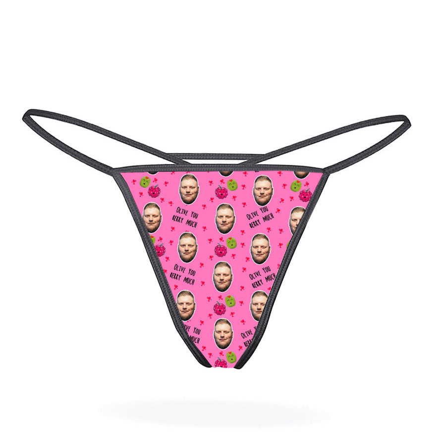 A pink thong with a pattern of cartoon characters displayed on the front.