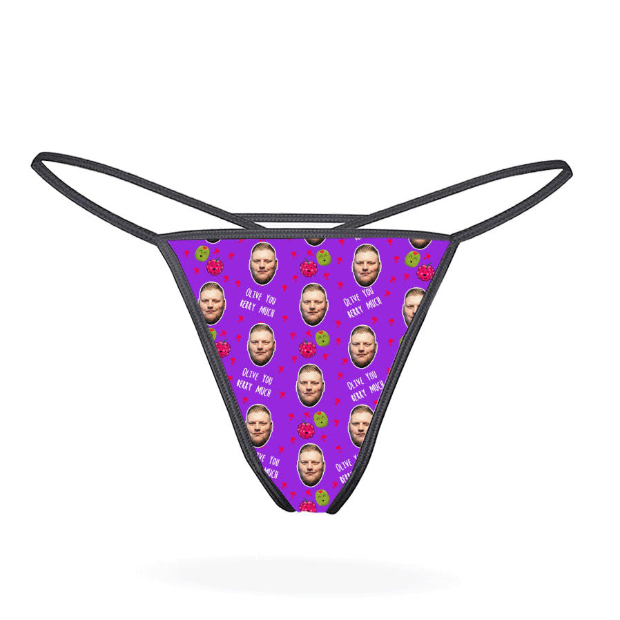 A pink thong with a pattern of cartoon characters displayed on the front.