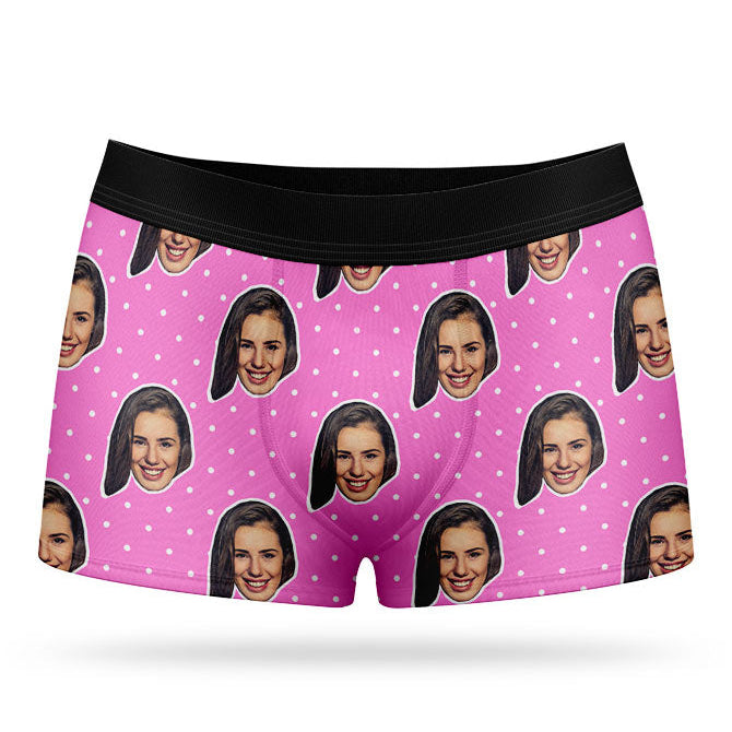 This image displays a pair of custom-designed boxer shorts, personalized with a high-resolution photo print of a female face on a vibrant pink background, complete with a polka dot pattern. The boxer shorts are crafted from a soft, stretchy cotton material, ensuring both comfort and durability.