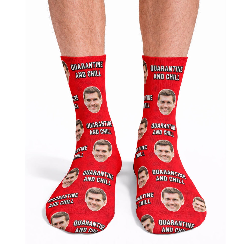 Red socks with 'Quarantine and Chill' text and face prints on a white background