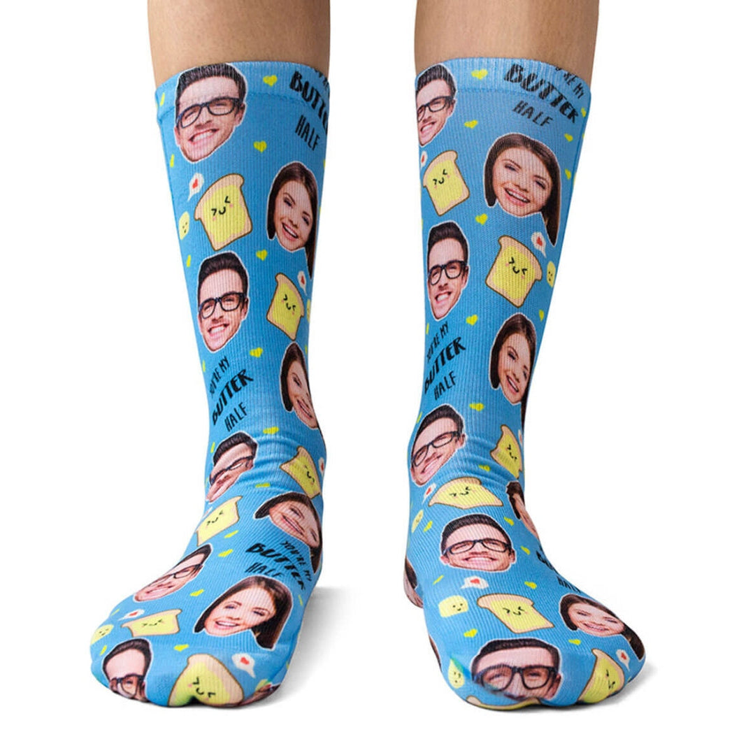 Blue socks with yellow cheese and face patterns on a white background