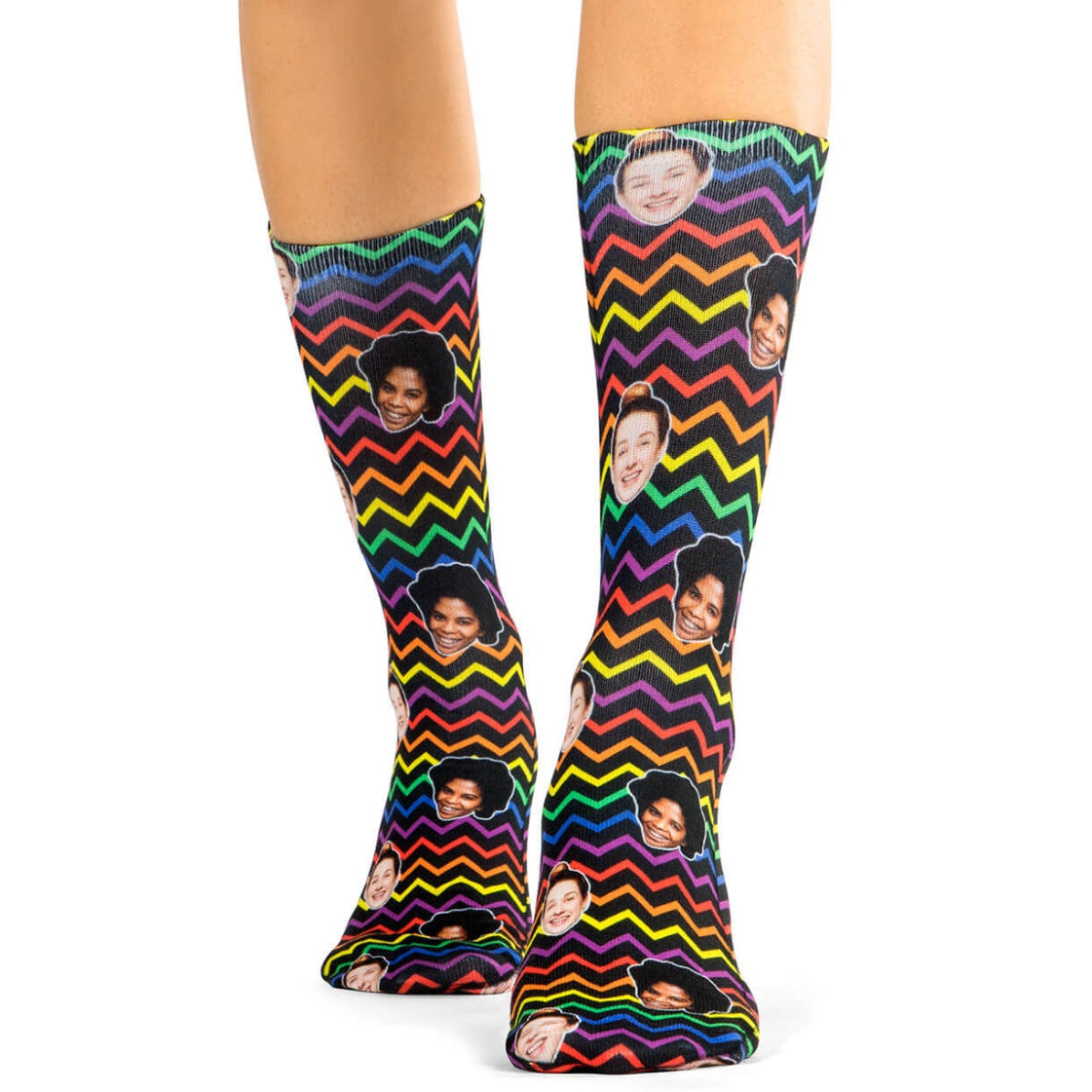 Colorful knee-high socks with zigzag pattern and face prints on a white background
