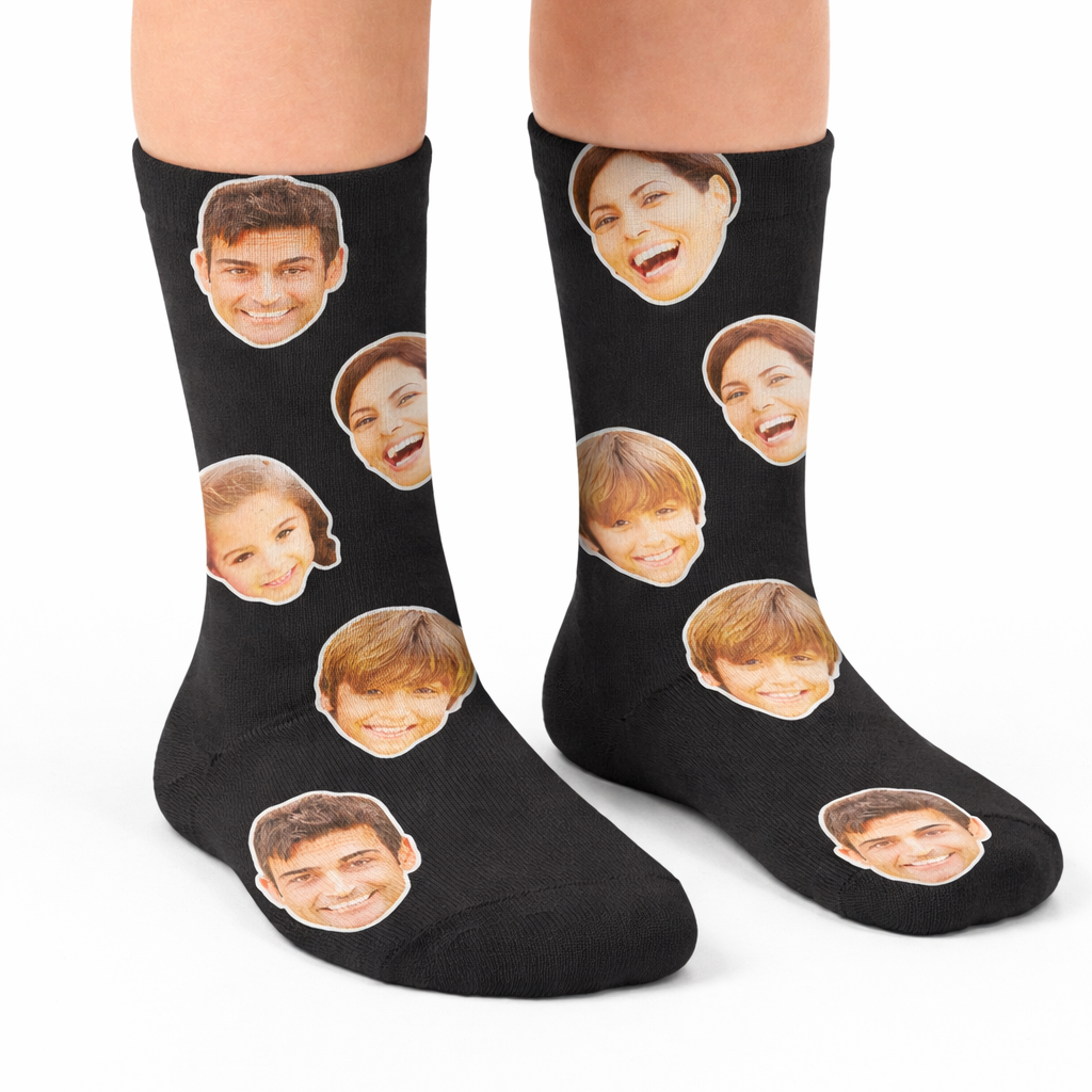 Black socks with printed faces worn by a person on a white background